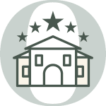 A simple illustration of a building with five stars above it, suggesting a rating or review, on a circular grey and white background.